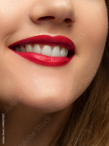 Close-up of woman s lips with fashion bright pink make-up. Beautiful female mouth  full lips with perfect makeup. Part of female face. Choice lipstick. Pink wavy hair of a doll