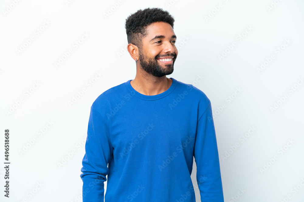 Young Brazilian man isolated on white background looking to the side and smiling Young Brazilian man isolated on white background looking to the side and smiling