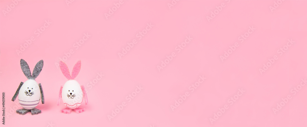 Easter. Easter bunnies, with their own hands on a pink background. Concept mocap and banner, congratulation, advertisement, invitation. High quality photo Easter. Easter bunnies, with their own hands on a pink background. Concept mocap and banner, congratulation, advertisement, invitation. High quality photo
