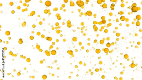 Chamomile oil is being poured into the water creating a lot of different sized clear yellow bubbles on white background | Abstract cosmetics formulation concept photo