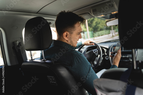 A young businessman arguing business on his phone while in his car
