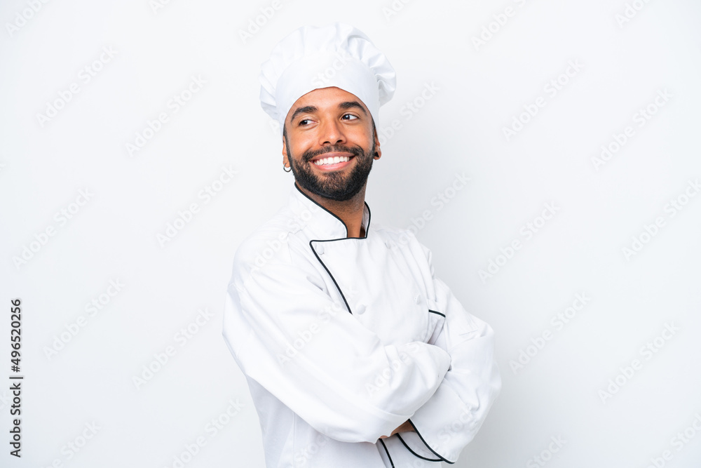 Young Brazilian chef man isolated on white background with arms crossed and happy Young Brazilian chef man isolated on white background with arms crossed and happy