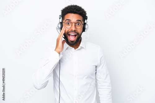 Telemarketer Brazilian man working with a headset isolated on white background with surprise and shocked facial expression