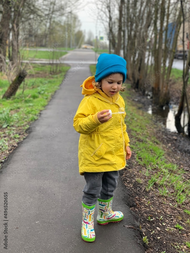 little Ukrainian girl in the spring in a raincoat little Ukrainian girl in the spring in a raincoat