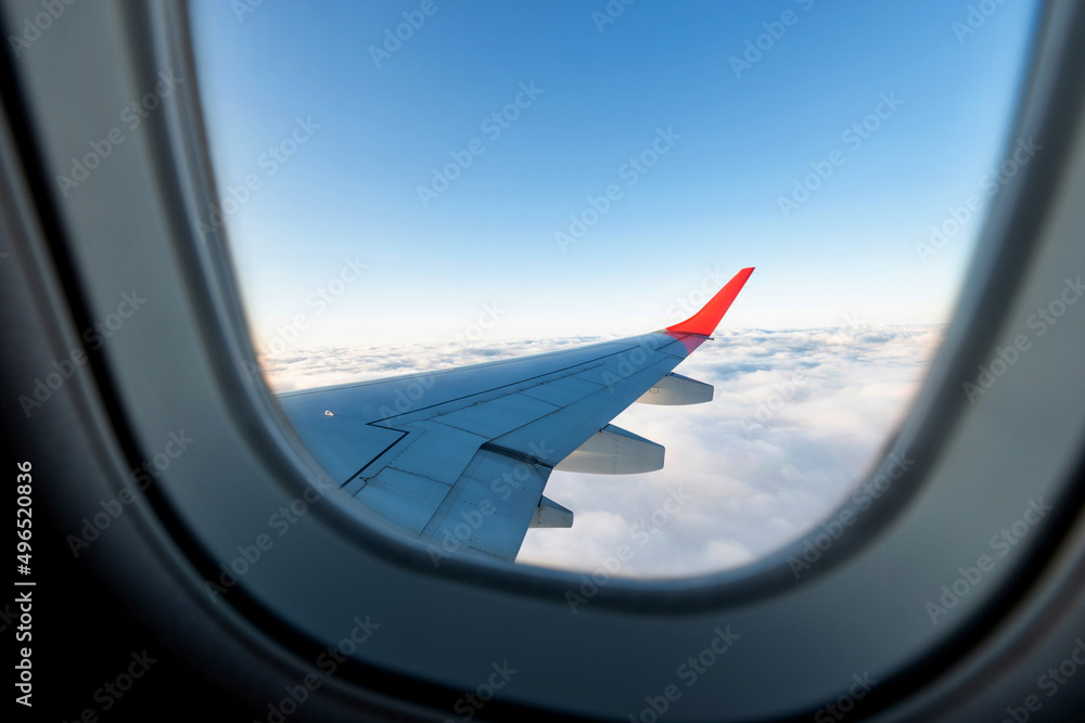 Looking at the sky and clouds through the airplane window Looking at the sky and clouds through the airplane window