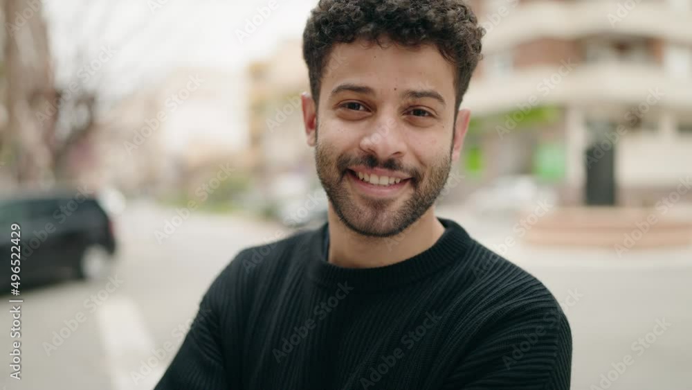 Young arab man smiling confident standing with arms crossed gesture at street Young arab man smiling confident standing with arms crossed gesture at street