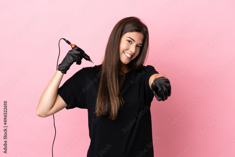 Tattoo artist woman isolated on pink background pointing front with happy expression Tattoo artist woman isolated on pink background pointing front with happy expression
