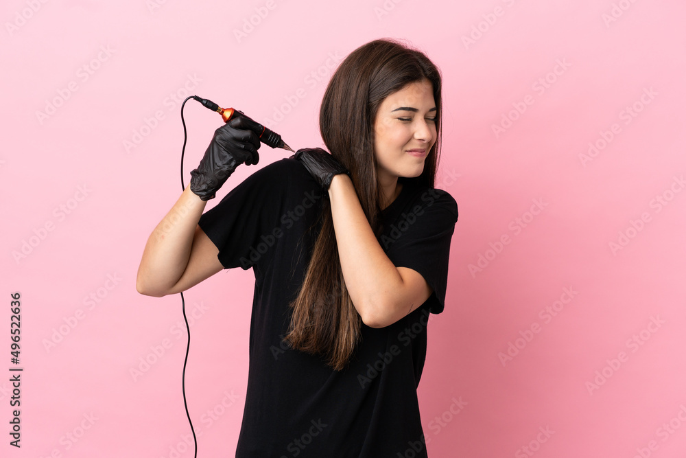 Tattoo artist woman isolated on pink background suffering from pain in shoulder for having made an effort Tattoo artist woman isolated on pink background suffering from pain in shoulder for having made an effort