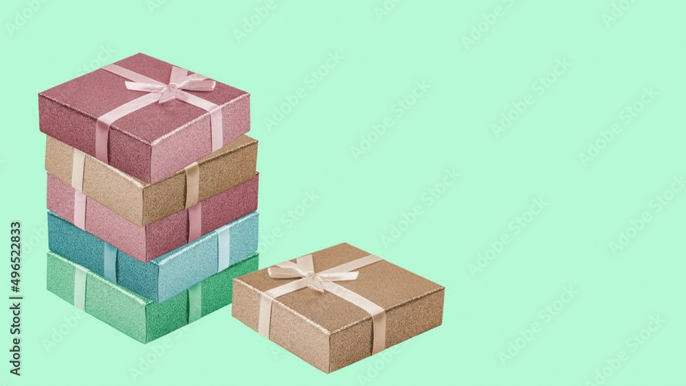 Stacks of beautiful gift boxes with ribbons on a pastel green background, the concept of an advertising banner for a sale or a holiday. Stacks of beautiful gift boxes with ribbons on a pastel green background, the concept of an advertising banner for a sale or a holiday.