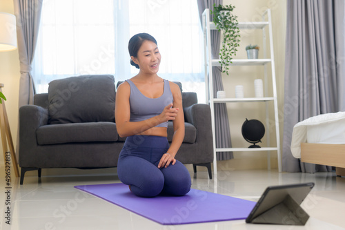 Professional yoga coach teaching online training class to students during live streaming on social media, healthcare concept