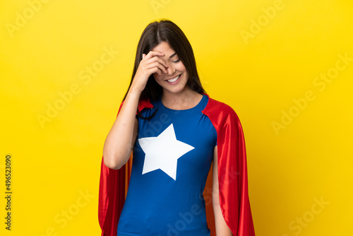 Super Hero Brazilian woman isolated on yellow background laughing © luismolinero