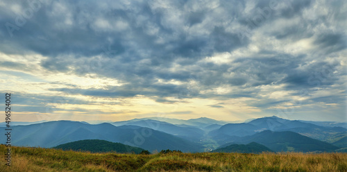 Panorama from the top of Mount Bozova in Transcarpathia, Ukraine. Summer evening in the Carpathian mountains. Beautiful cloudy sky over the villages of the valley