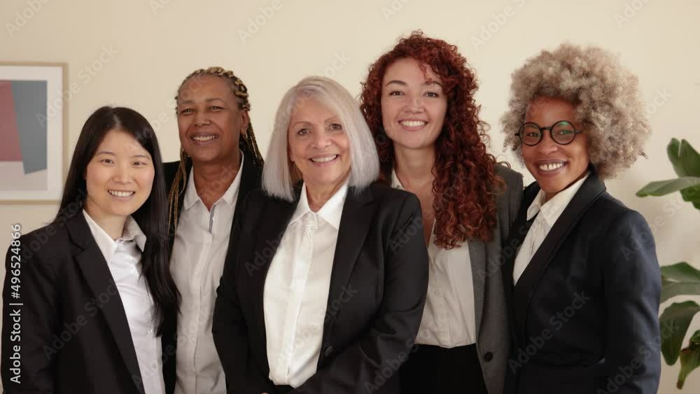 Multiracial business women smiling together inside bank office Multiracial business women smiling together inside bank office
