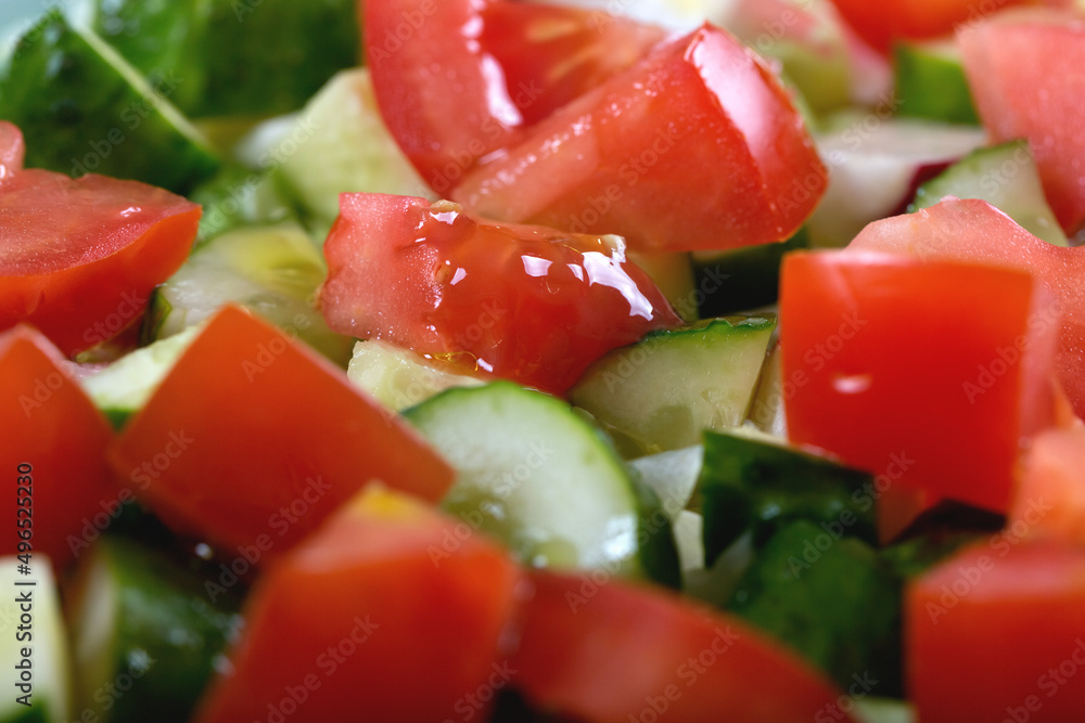 Macro shot of delicious juicy tomato and cucumber salad with herbs and onions Macro shot of delicious juicy tomato and cucumber salad with herbs and onions