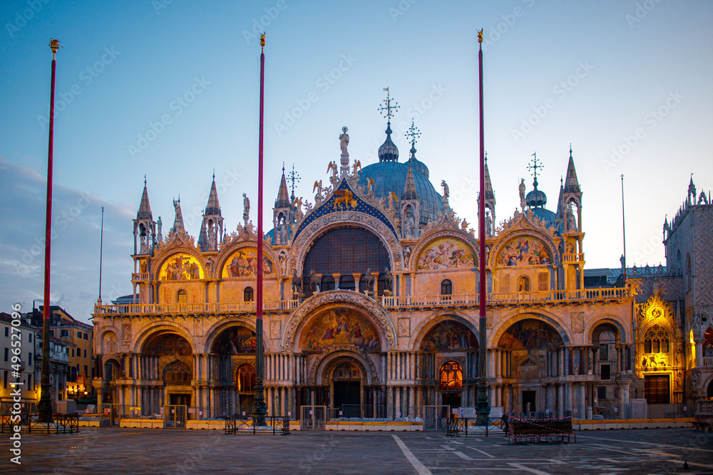 An empty St Marks square in Venice with the bell tower and the cathedral at dawn