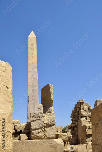Ruins of Karnak Temple complex with statues, sculptures and pillars carved with ancient Egyptian hieroglyphs and symbols (ancient Thebes). Luxor, Egypt