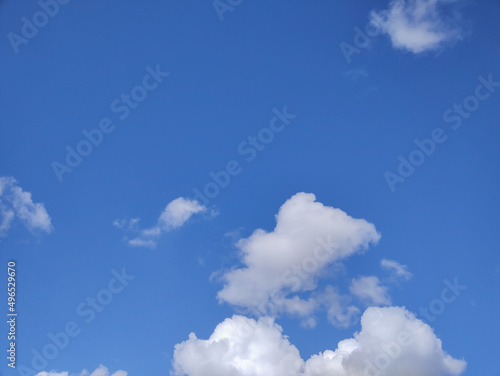 White cloudy and fluffy cloud on bright and blue sky surface background in spring season