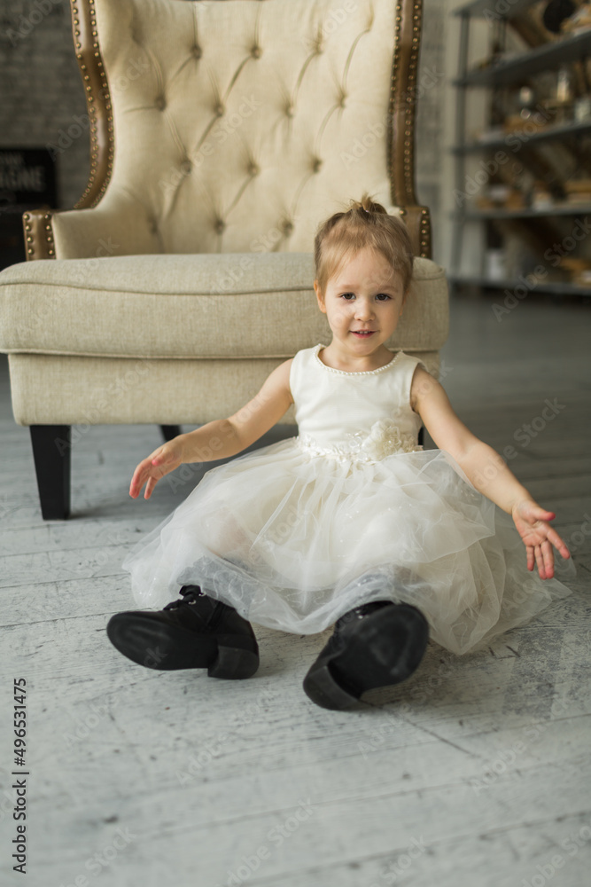 little girl looks like a princess, laughs on the floor