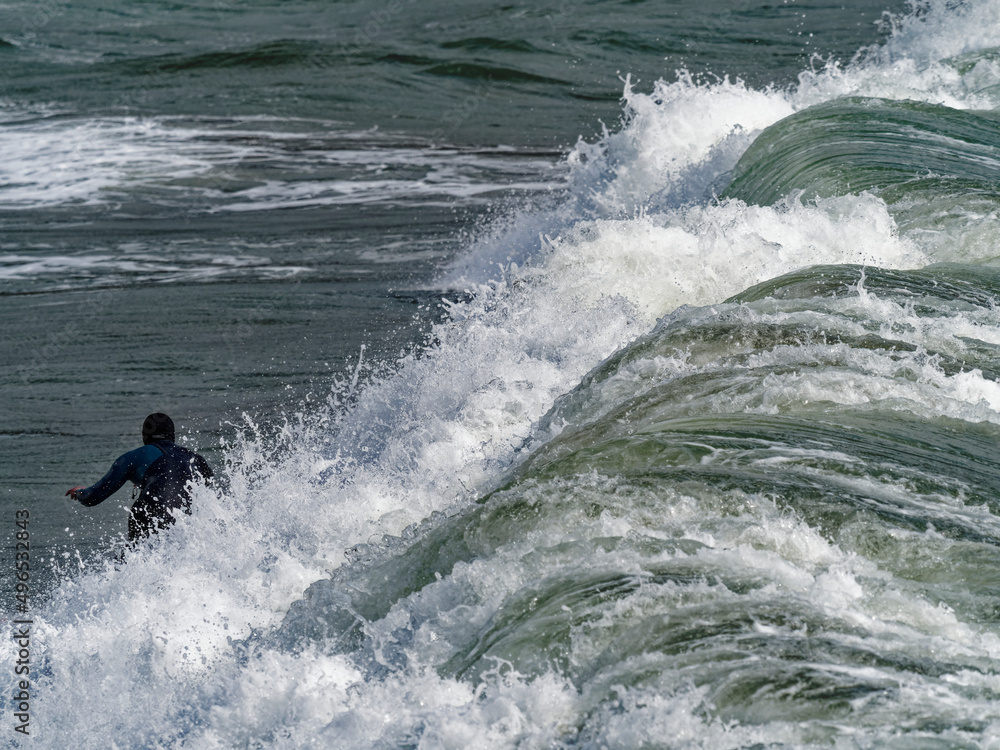 a surfer surf a wave in italy