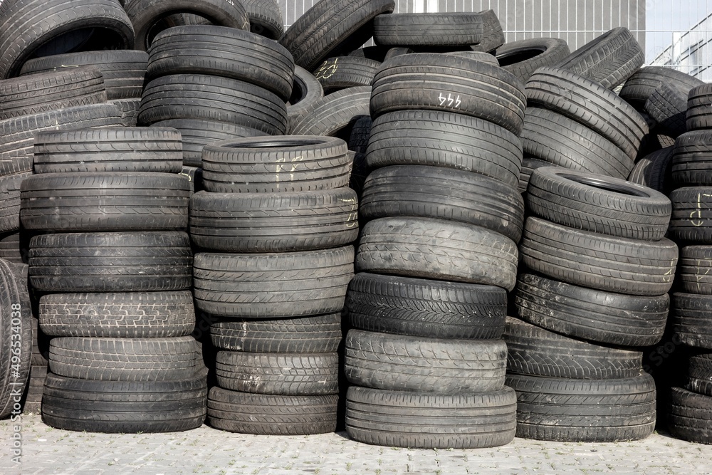 Piles of old rubber tyres with worn out threads Piles of old rubber tyres with worn out threads