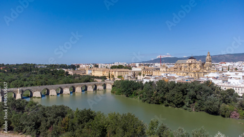 Aerial view of the old medieval city of Cordoba in Andalusia, Spain during a sunny day. Medieval mosque cathedral and Roman bridge over Guadalquivir river, UNESCO World Heritage site. Tourism. 