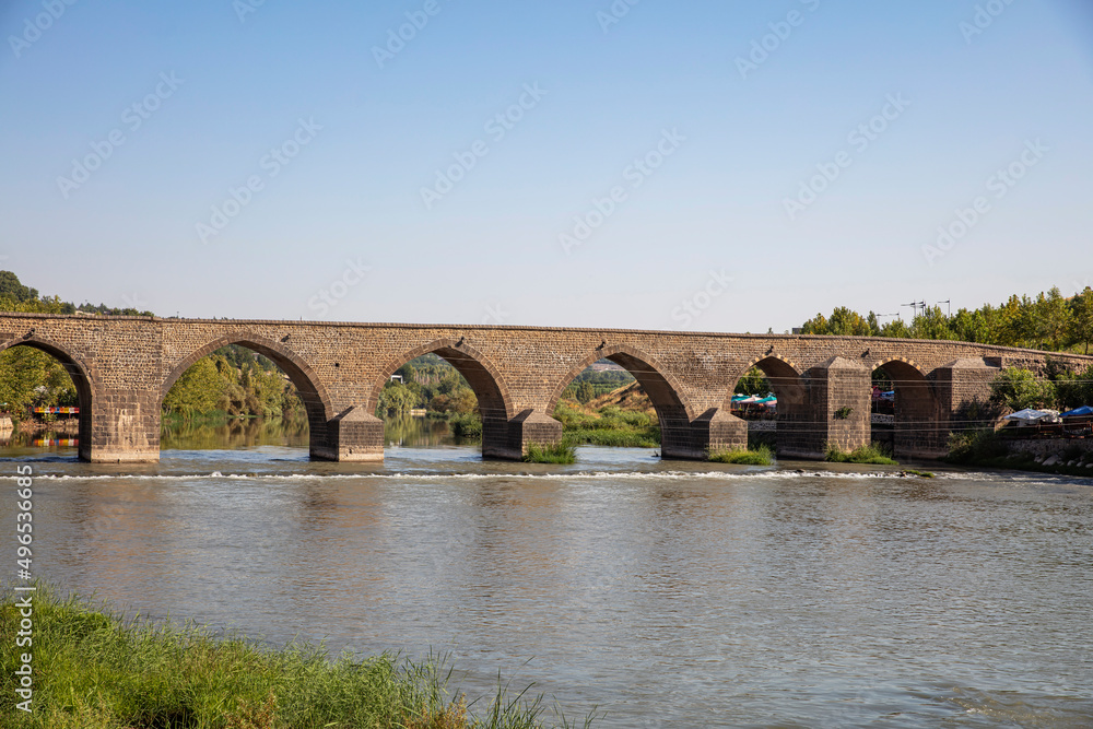 Fototapeta premium Historical Diyarbakır ten-eyed bridge and reflection of the Tigris river