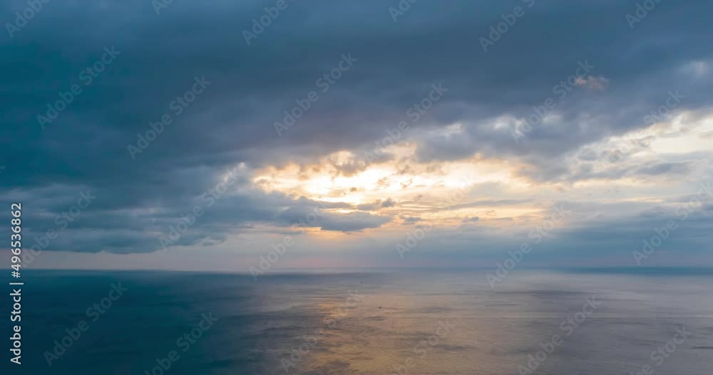 Scenic time lapse of evening cloudscape under sea. Beautiful sunset, motion of dark blue rain clouds, storm front moving Scenic time lapse of evening cloudscape under sea. Beautiful sunset, motion of dark blue rain clouds, storm front moving
