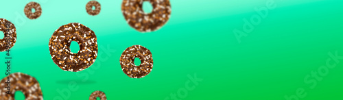 Glazed icing brown sweet sugar chocolate doughnut donut dessert on green pastel background banner. Creative minimal blurred selective focus collage food mockup concept with copy space