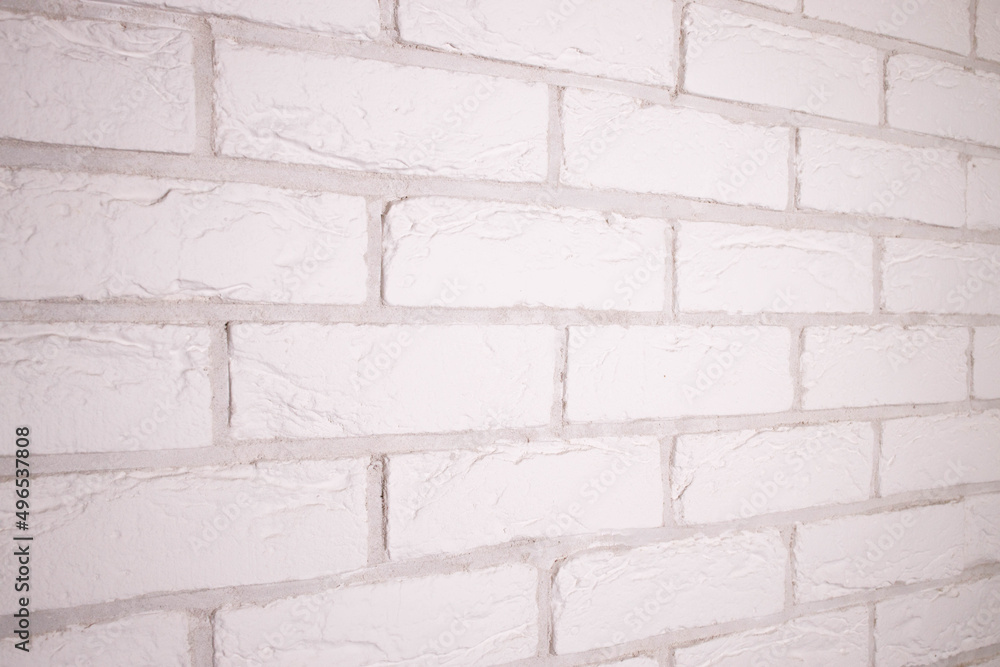Obraz premium Textured white brick background. Decorative tiles for wall decoration. White decorative brick. Loft decor style. Structural surface that mimics brick