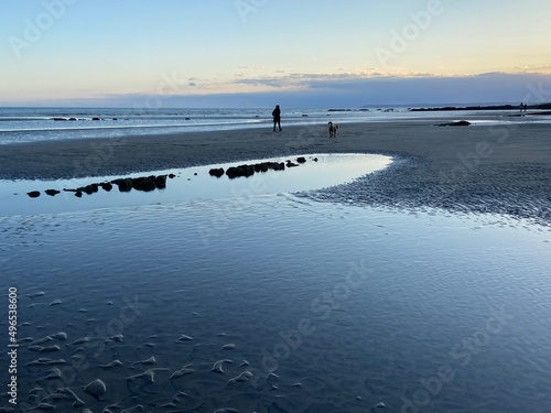 Hastings beach at low tide sea gone out, sunset reflecting on wet sand, Hastings, East Sussex, UK photo