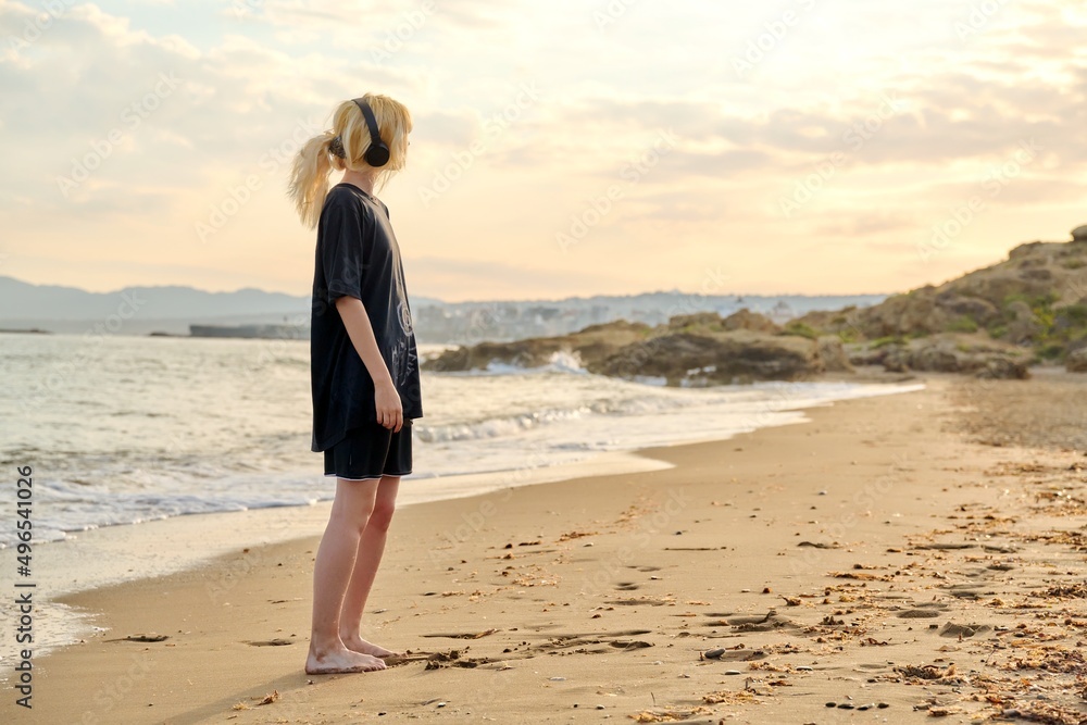 Young teenage female on the beach in the morning Young teenage female on the beach in the morning
