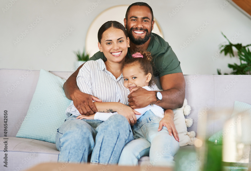Cuddling up to a carefree day. Portrait of a happy family relaxing together at home.