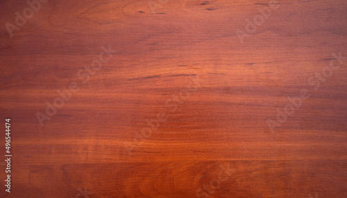 Rectangular texture made of natural mahogany. Wooden background for red wood text.