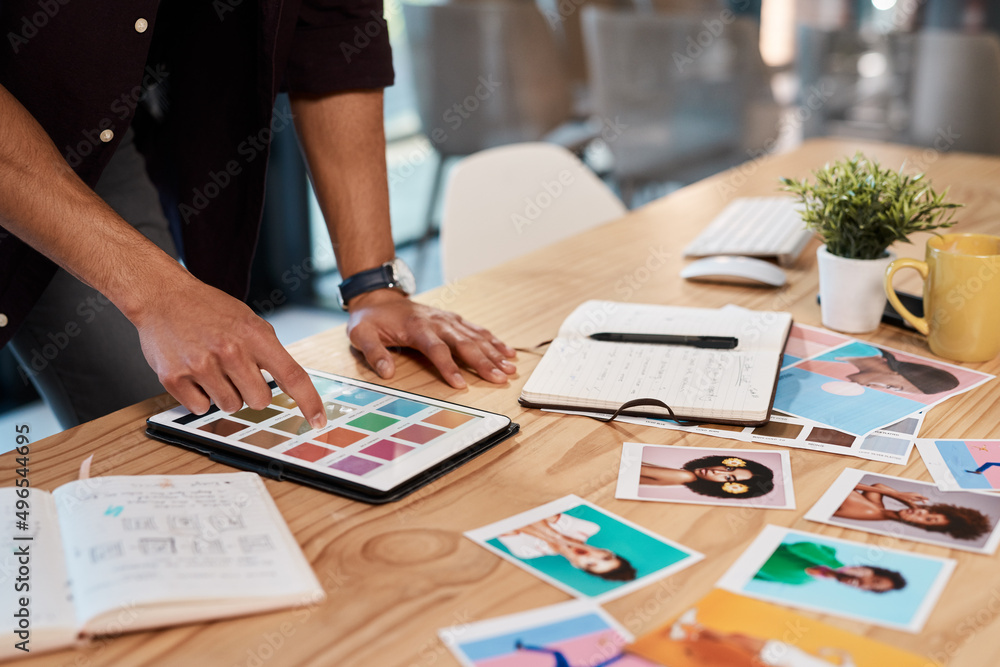 So many colours to choose from. Cropped shot of an unrecognizable businessman standing alone in his office and using a tablet to view colour swatches.