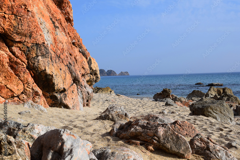 red stone rock near the sea