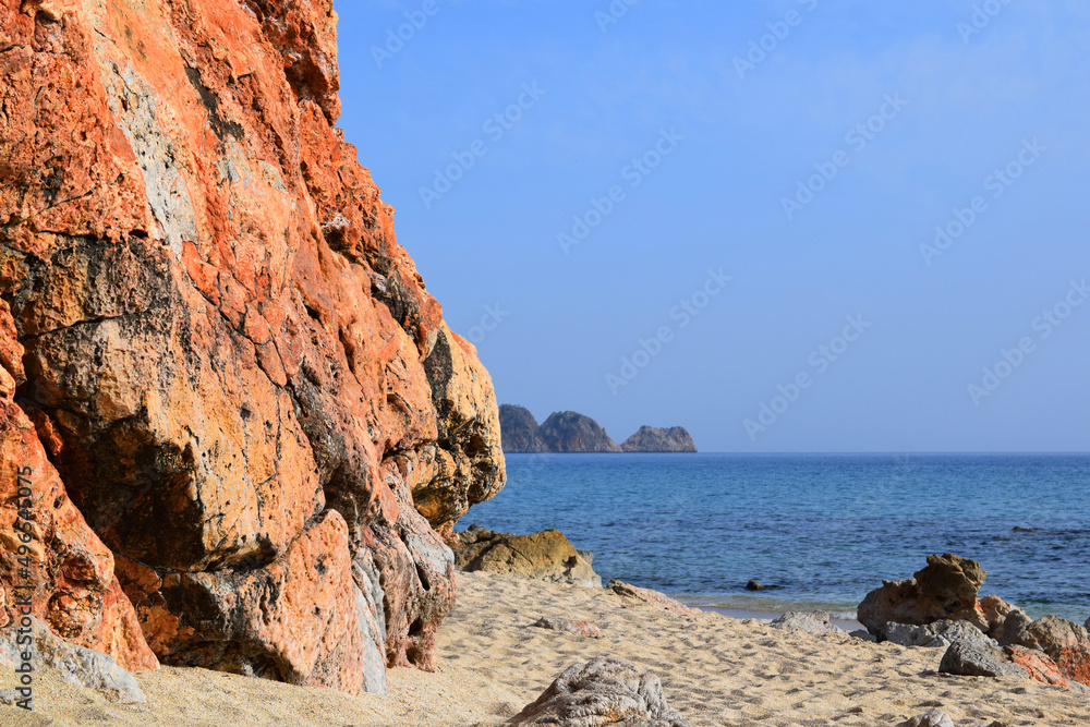 red stone rock near the sea