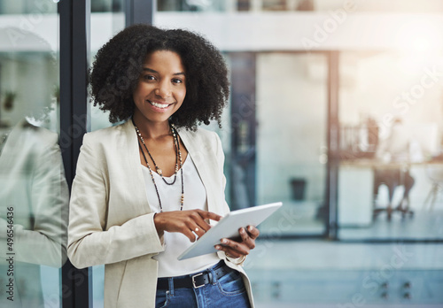 Make it your business to be tech savvy and industrious. Portrait of a young businesswoman smiling and holding a digital tablet in her office.