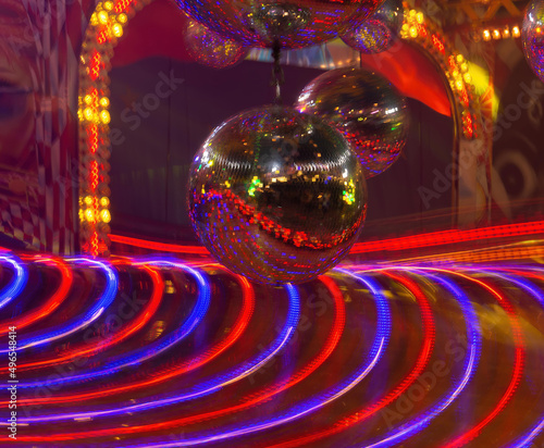 a disco ball over a spinning ride
