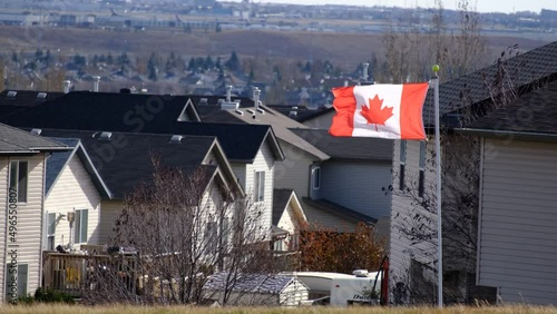 Canadian Maple leaf flag flying over residential surburb in Calgary photo