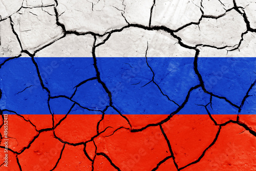 Flag of Russia and Ukraine on the texture of dry cracked earth. Relations between Ukraine and Russia
