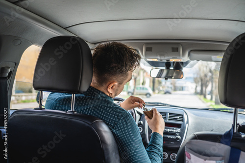 One man adult caucasian male drinking alcohol from flask while drive a car drunk back view copy space alcoholism and alcohol abuse concept intoxicated dangerous driver © Miljan Živković