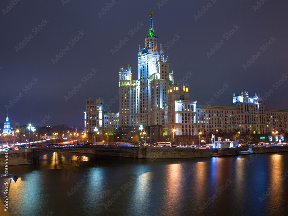 Evening picture of high building on river. Moscow, Russia