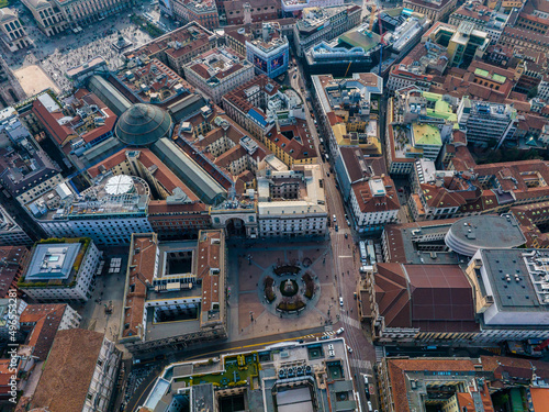 Aerial view of Piazza Duomo in front of the gothic cathedral in the center. Drone view of the gallery and rooftops during the day. Milan. Italy,