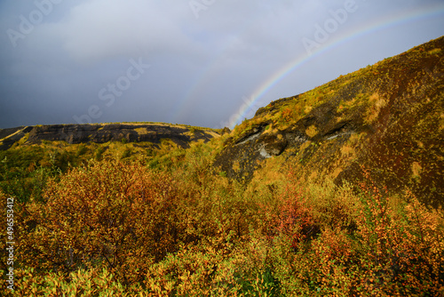 A rainbow above the fall foliage of the enchanting Woods of Thor on the hike back from the summit of Mt. Valahnúkur, Thórsmörk National Park, Iceland