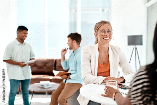 Its an awesome work environment. Cropped shot of a group of young businesspeople socializing in their office.