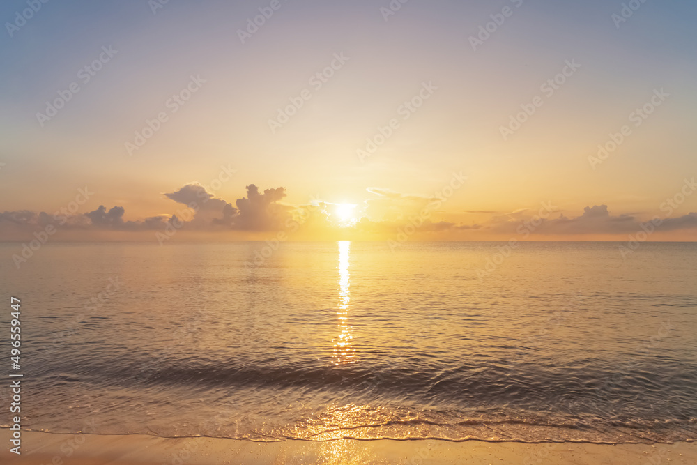 Fototapeta premium Tropical beach with smooth wave and sunset sky abstract background.