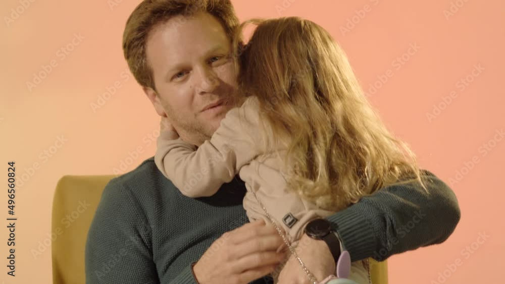 Young male with hugs his daughter Young male with hugs his daughter