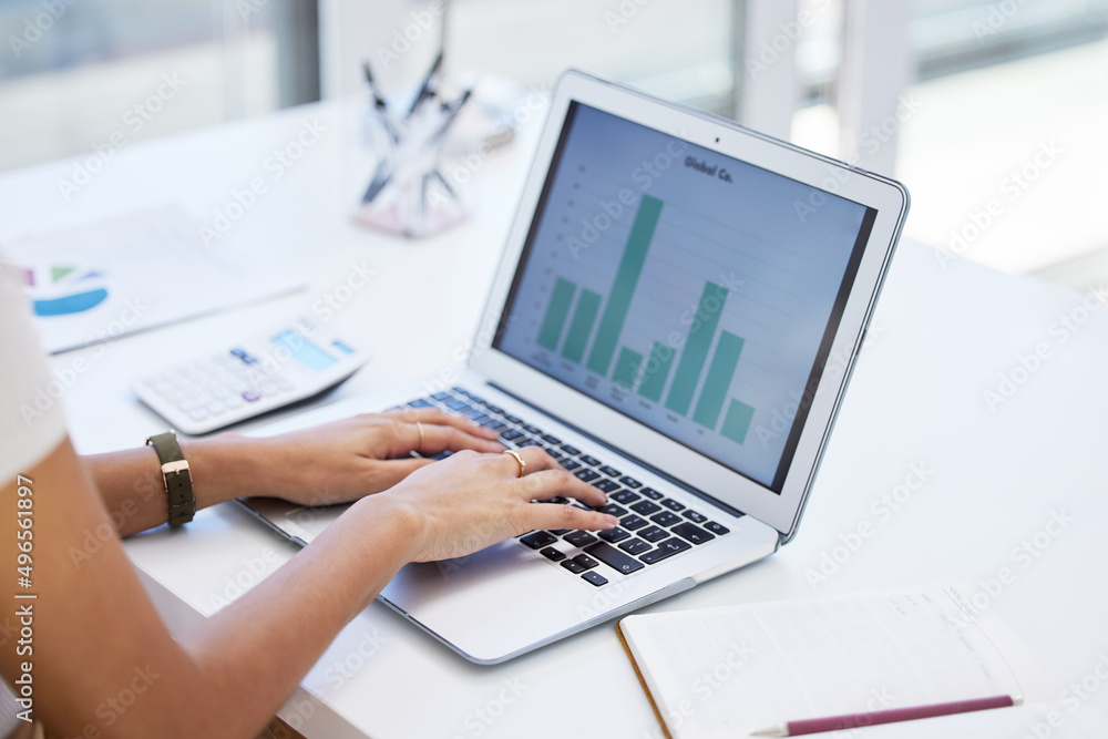 Taking the day to attend to my finances. Shot of a businesswoman using her laptop to compile spreadsheets. Taking the day to attend to my finances. Shot of a businesswoman using her laptop to compile spreadsheets.