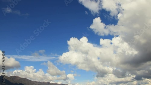 Many clouds in the sky going to the top of The Twins peaks, from the dam view in the mountains of  Córdoba province´s, Argentina