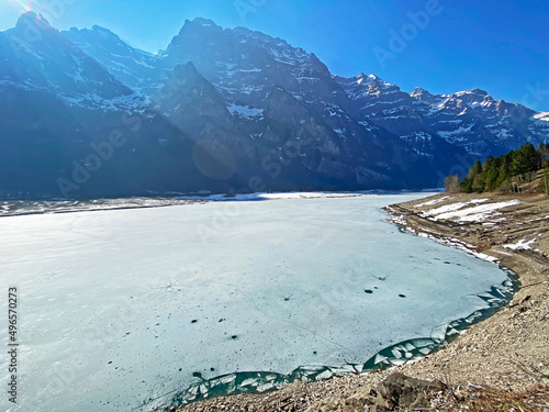 Frozen Klöntalersee or Klontaler Lake during early spring in the Alpine valley Klöntal (Kloental or Klontal) and in the Glarus Alps mountain massif - Canton of Glarus, Switzerland (Schweiz) photo